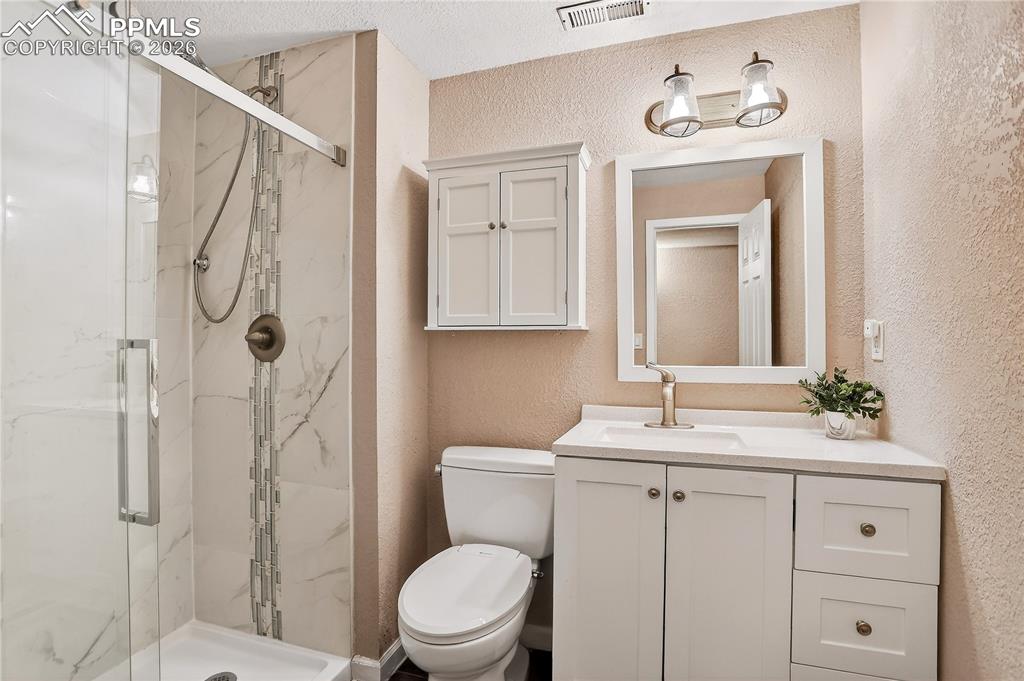 Image 14 of 20: Remodeled guest bath