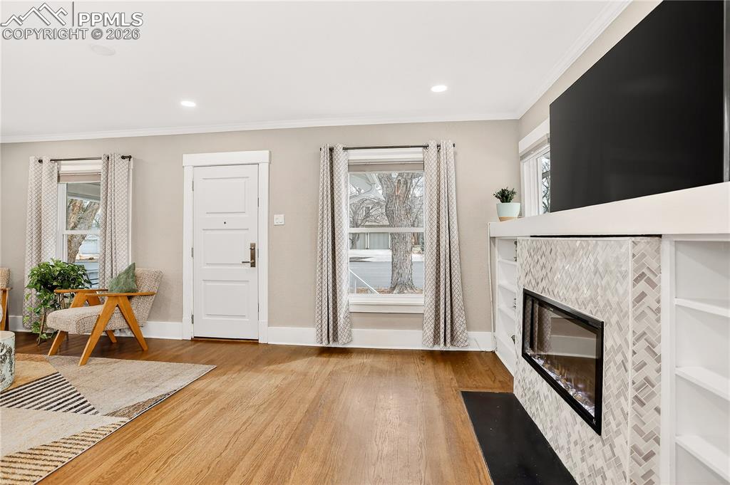 Image 3 of 20: Beautiful hardwood flooring and tile surround fireplace