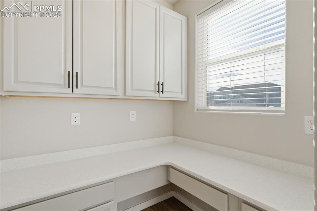 Image 10 of 50: Built in office behind the barn door.