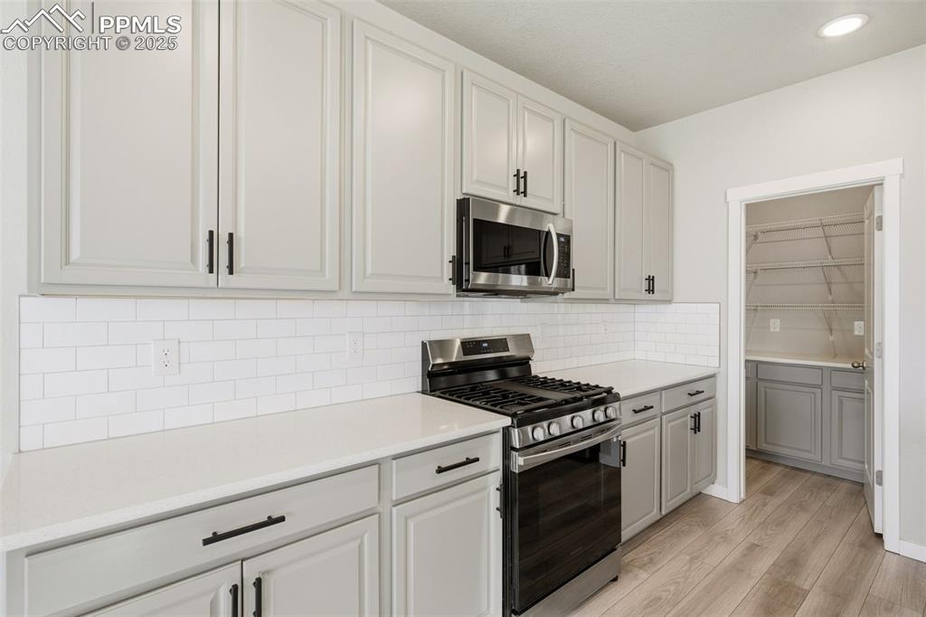 Image 13 of 50: Plenty of counter tops for baking and creating new dishes. Huge walk-in pan