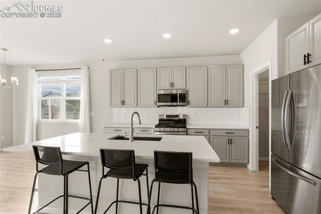 Image 14 of 50: With Beautiful quartz counter tops and big island.