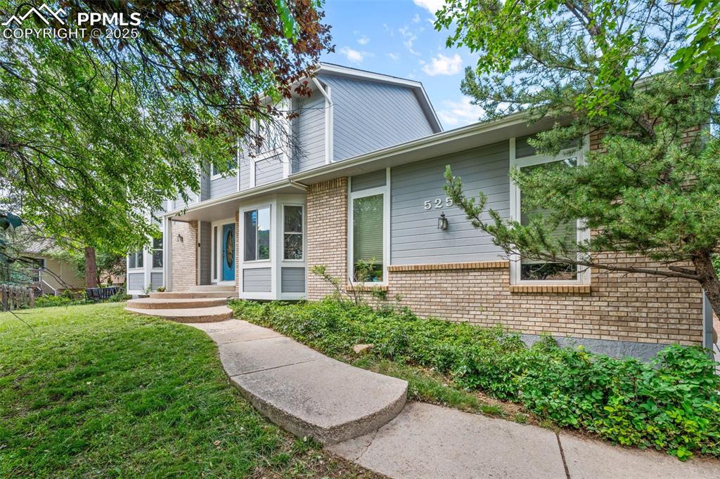 Image 2 of 50: View of front of property featuring brick siding and a front lawn