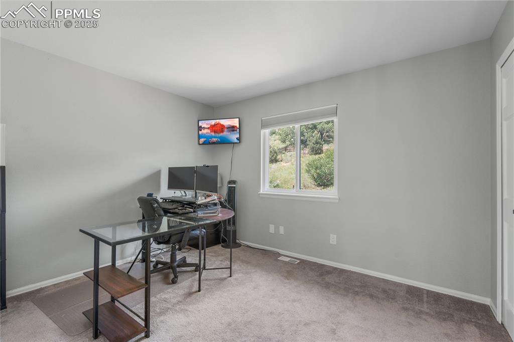 Image 28 of 50: Carpeted office featuring baseboards