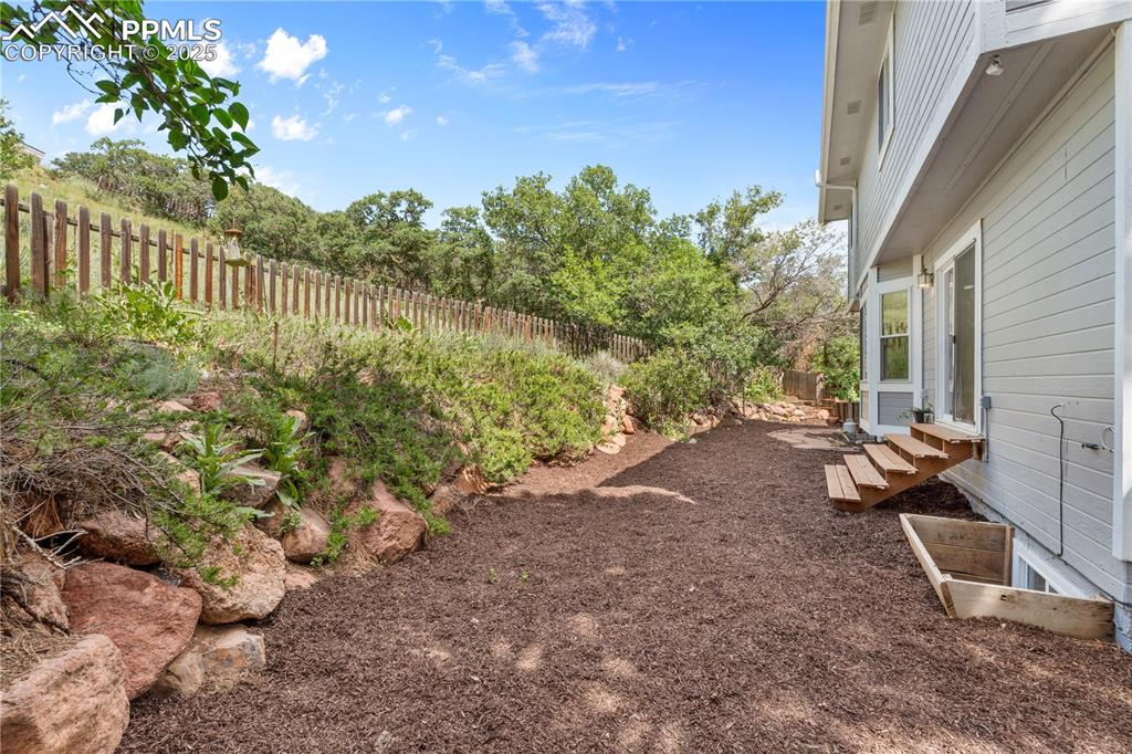 Image 39 of 50: Fenced backyard featuring entry steps