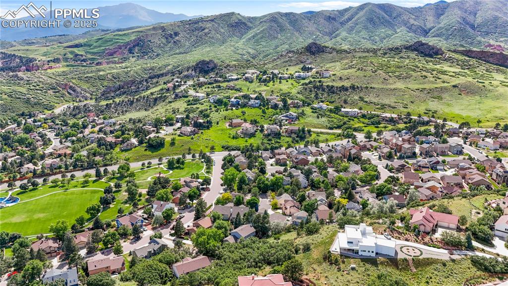 Image 43 of 50: Aerial perspective of suburban area featuring a mountainous background