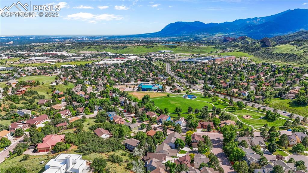 Image 47 of 50: Aerial perspective of suburban area with mountains