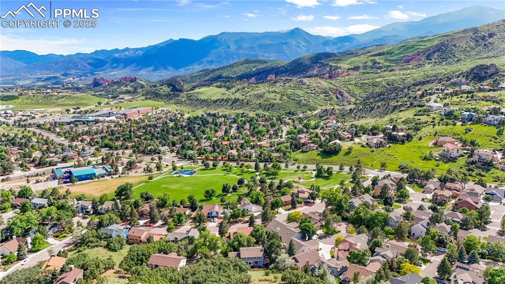 Image 49 of 50: Aerial perspective of suburban area featuring a mountainous background