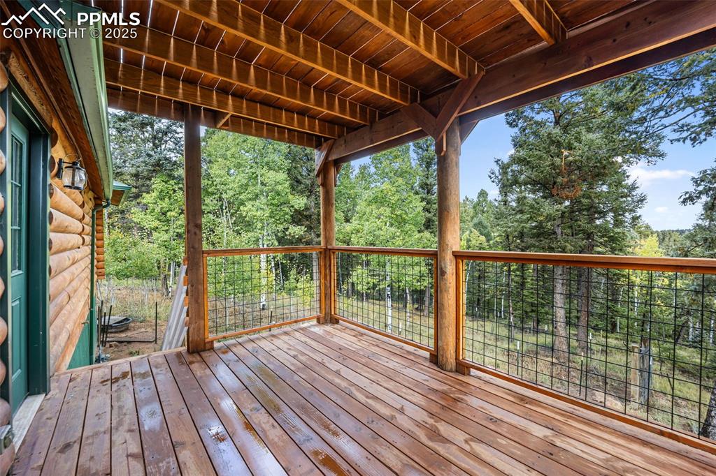 Image 30 of 48: Deck off of kitchen/back porch with stairs 