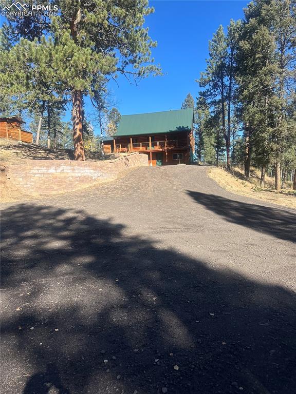 Image 46 of 48: View of front facade featuring a metal roof