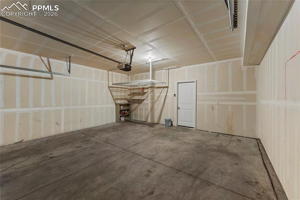 Image 20 of 21: Garage with a garage door opener