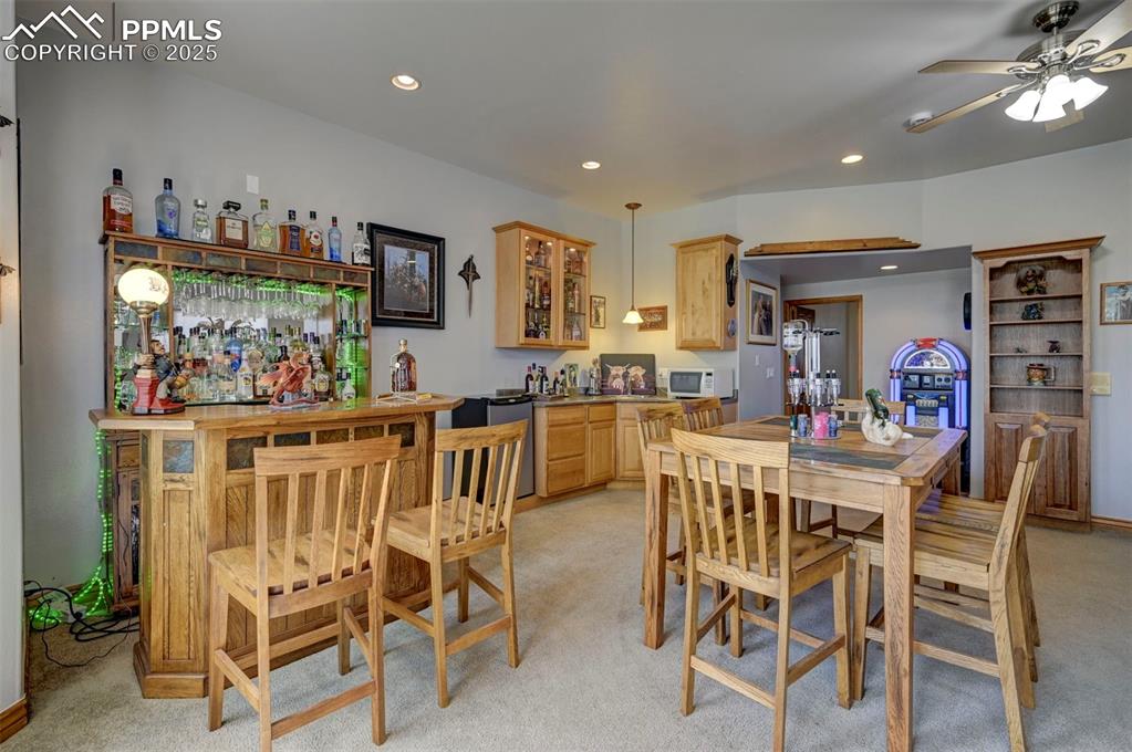 Image 27 of 50: Family room in basement with wet bar and walk out