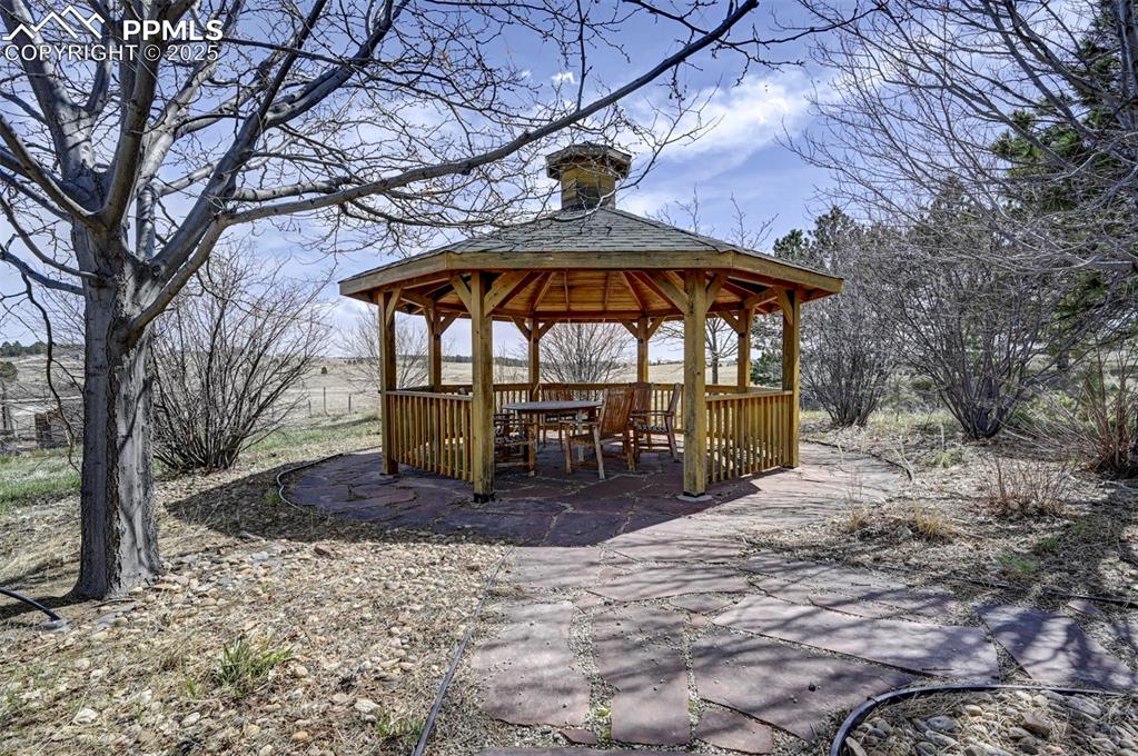 Image 28 of 50: Gazebo surrounded by mature trees