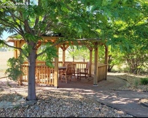 Image 29 of 50: Gazebo in the summer months with the trees full of folliage