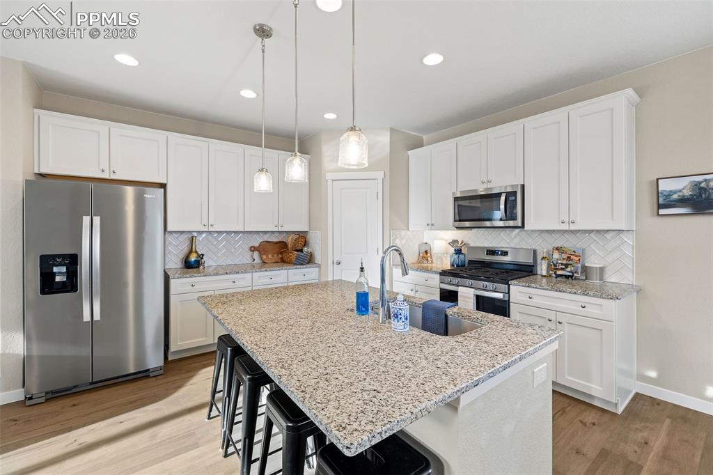 Image 13 of 37: The stainless refrigerator/freezer is spacious and the kitchen layout is pe