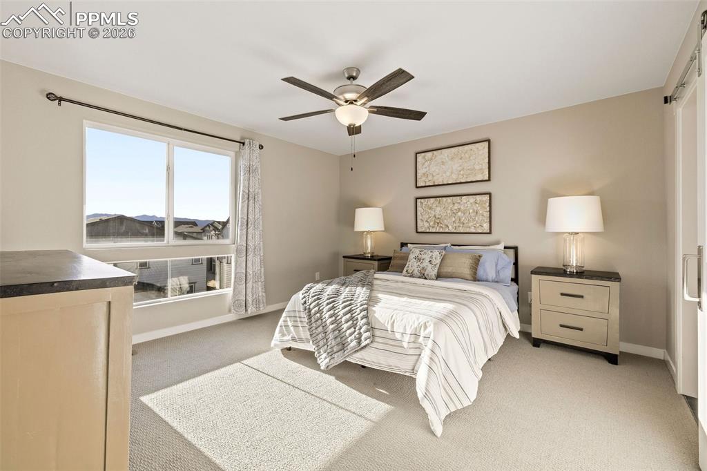Image 15 of 37: The primary bedroom is spacious enough for a king-sized bed and all your fu