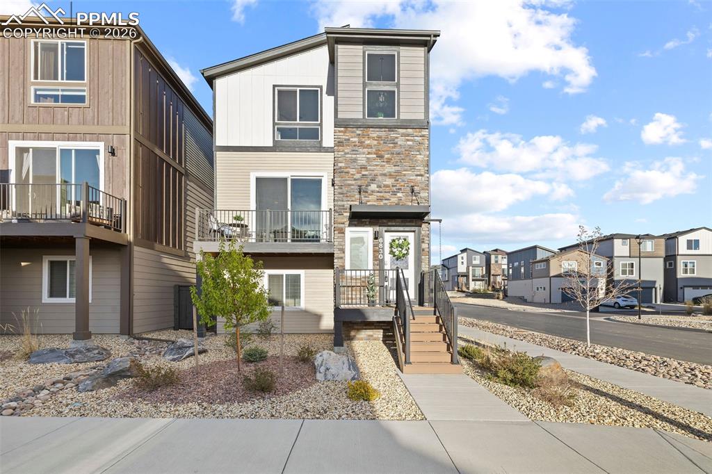 Image 2 of 33: The front porch and spacious balcony face west for gorgeous sunset views an