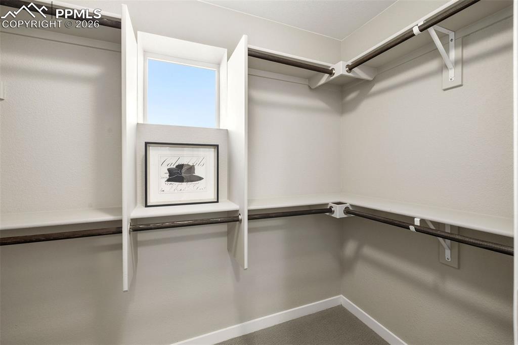 Image 20 of 33: The primary suite has a spacious walk-in closet.
