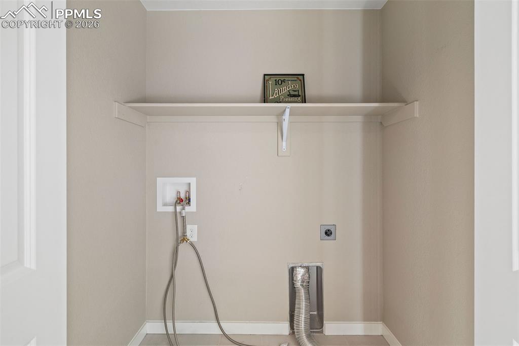 Image 23 of 37: The laundry area is conveniently located across from the primary bedroom an