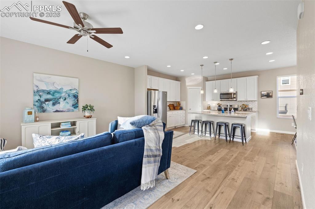 Image 3 of 33: The living room is spacious and open to the kitchen and dining area. 