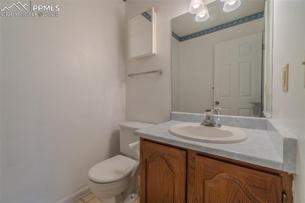 Image 20 of 48: Half bath on main off the entrance from the garage