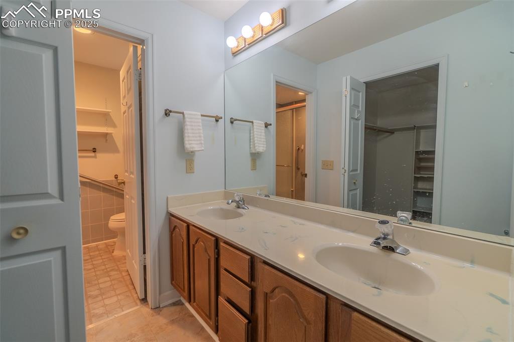 Image 23 of 48: Primary bath with dual vanity