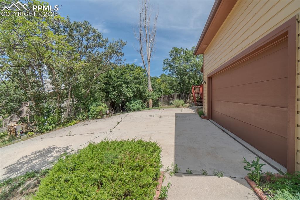 Image 3 of 48: View from 2 car garage leading to back deck with seasonal mountain views