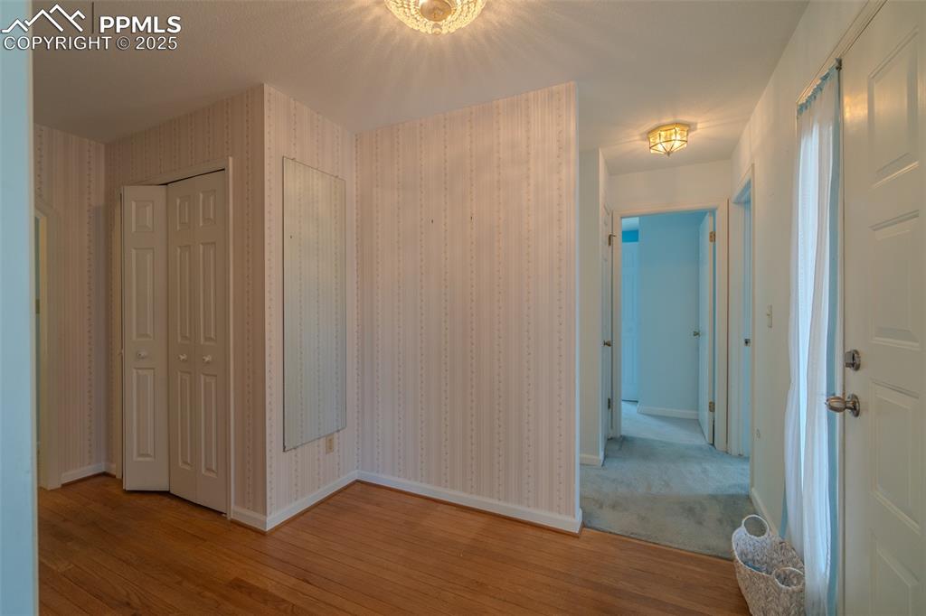 Image 6 of 48: Welcoming entry with hardwood floors