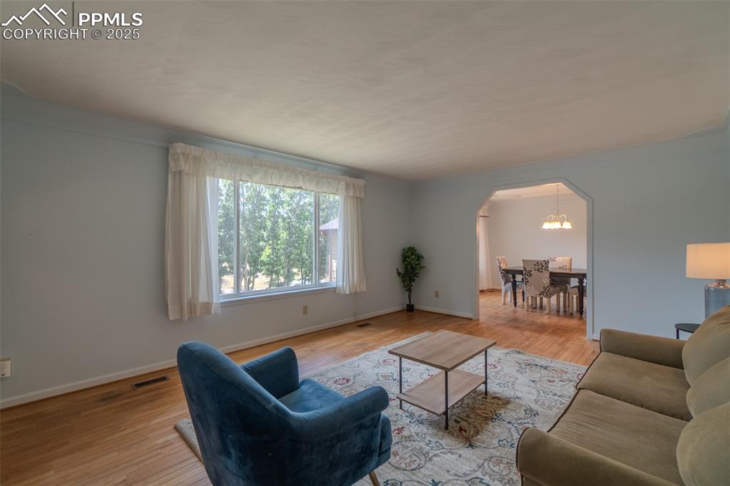 Image 7 of 48: Formal living room with hardwood floors
