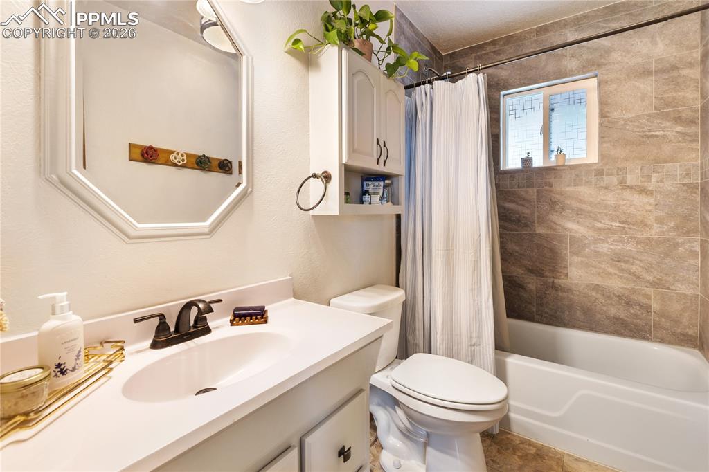 Image 13 of 42: Full bath with vanity, shower/bath combination, and extra storage above the