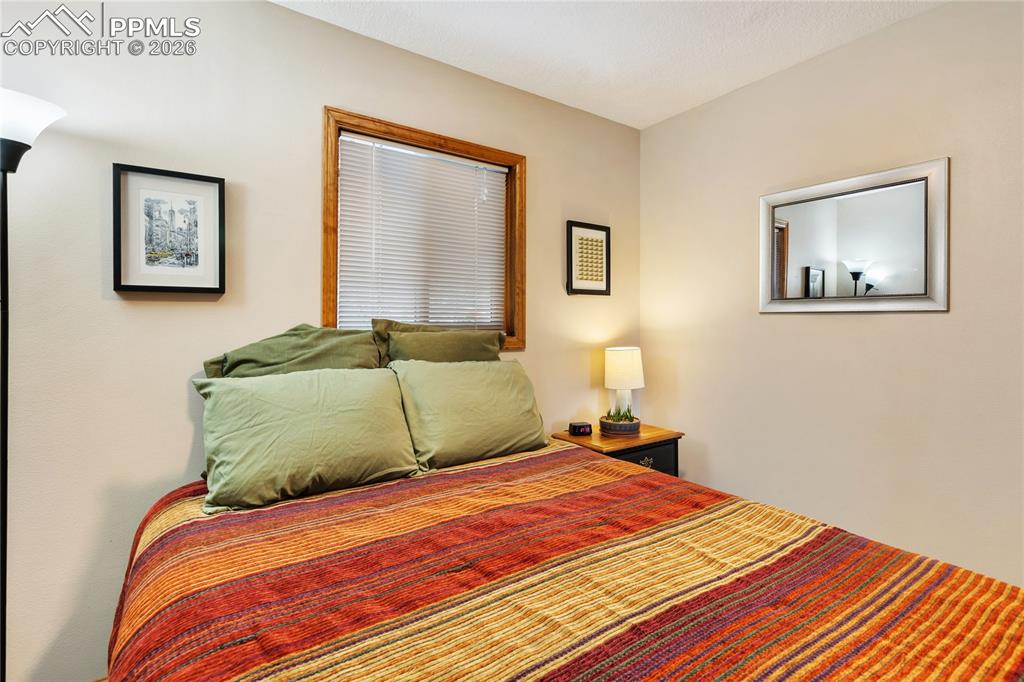 Image 18 of 42: The secondary bedroom features wood trim and a window!