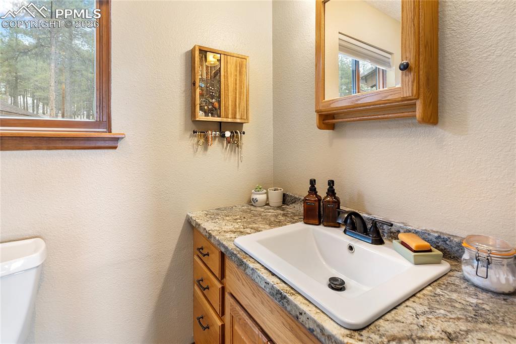Image 19 of 42: The 3/4 bathroom features a window for natural light, a medicine cabinet, a