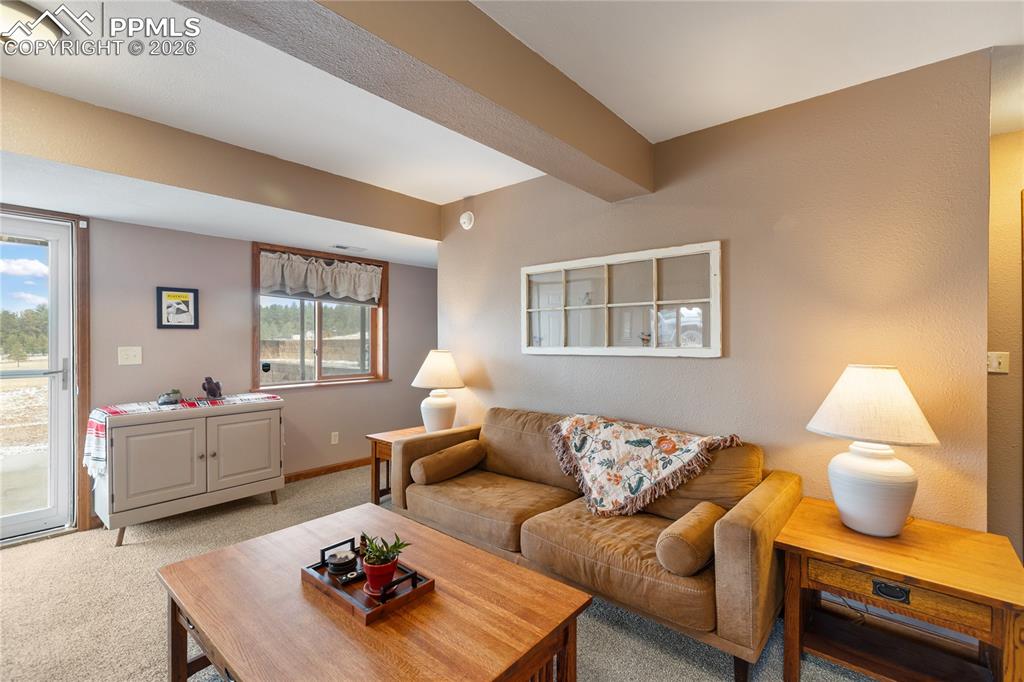 Image 20 of 42: The living room has rich wood trim and an architectural soffit detail!