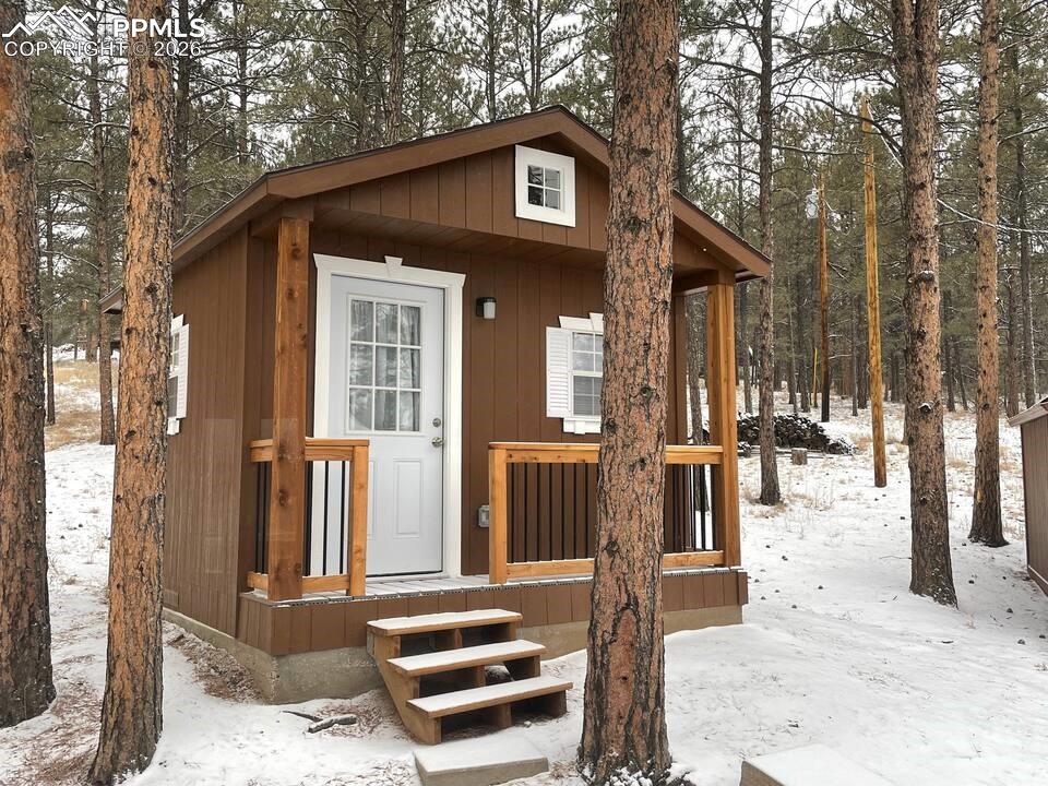 Image 24 of 42: The property also features an outdoor-access bunkhouse!