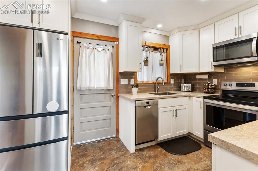 Image 3 of 42: The kitchen has stainless steel appliances and a window over the sink!