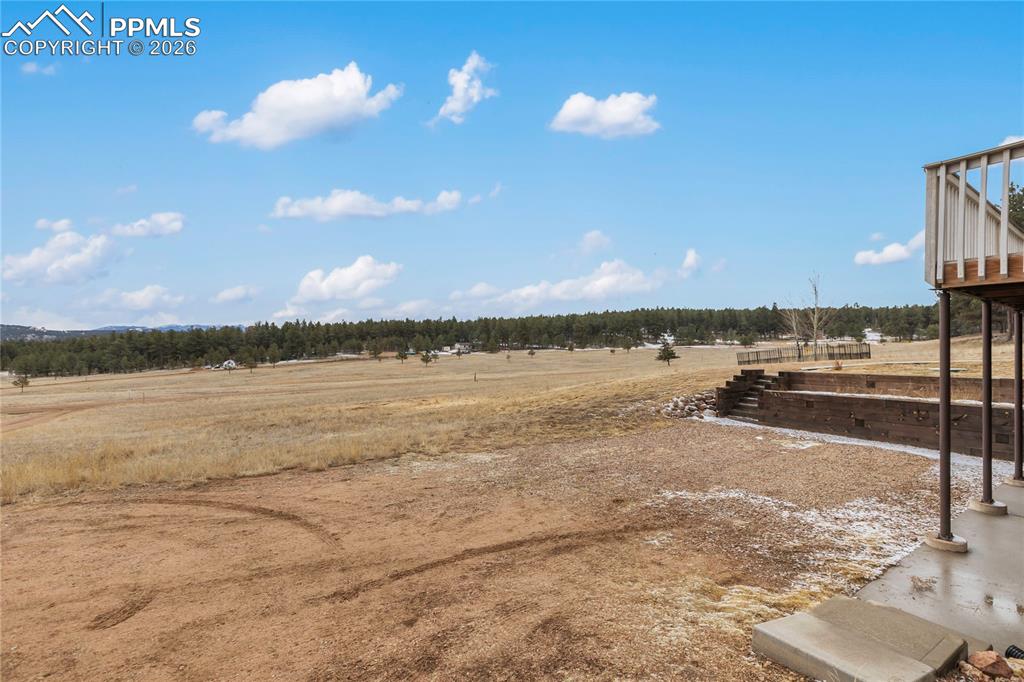 Image 31 of 42: The front yard has a beautiful view of the meadow!