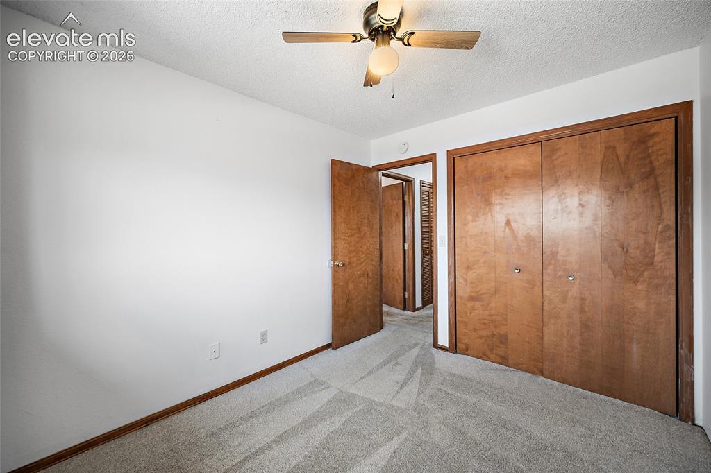 Image 13 of 26: Bedroom featuring light gray patterned carpet and neutral white walls