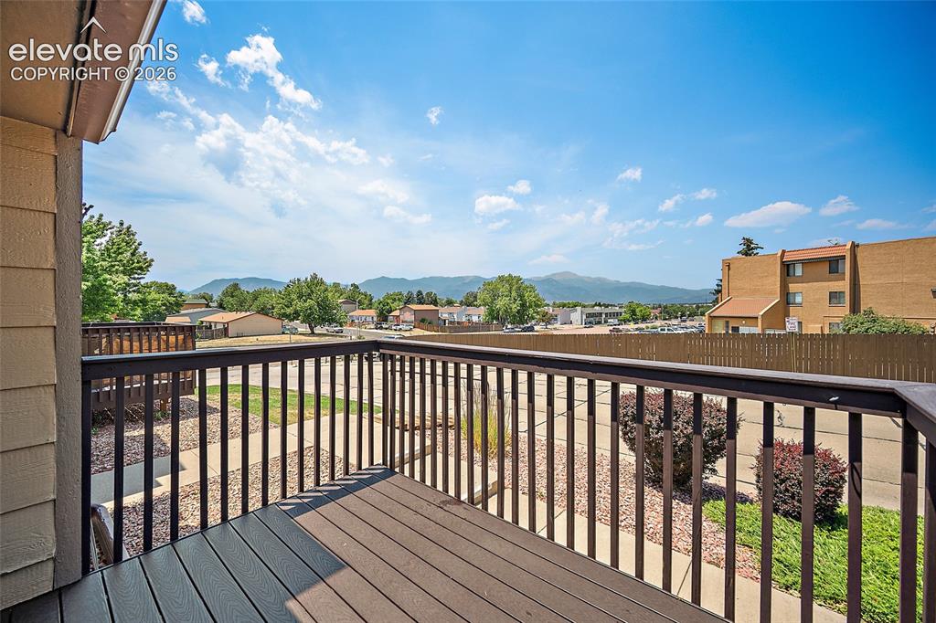 Image 18 of 26: Outdoor balcony featuring composite decking and dark railings, offering mou