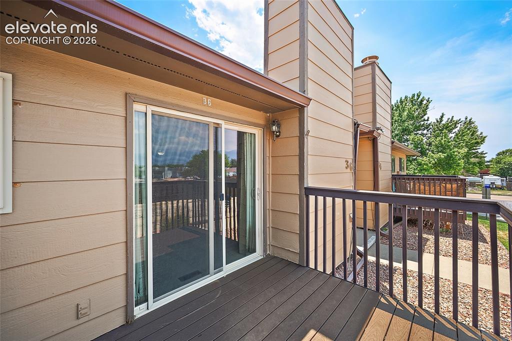 Image 19 of 26: Private outdoor deck featuring durable dark-toned composite decking and a m