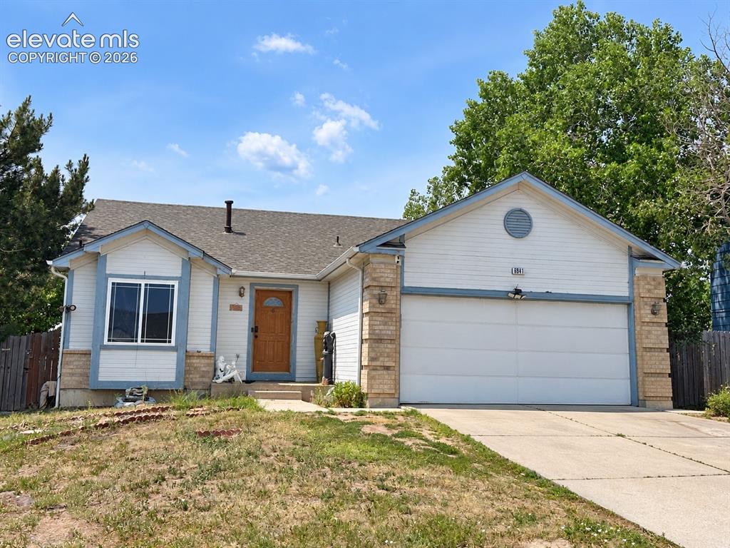 Image 1 of 1: Single-story residence featuring a two-car garage, concrete driveway, and a