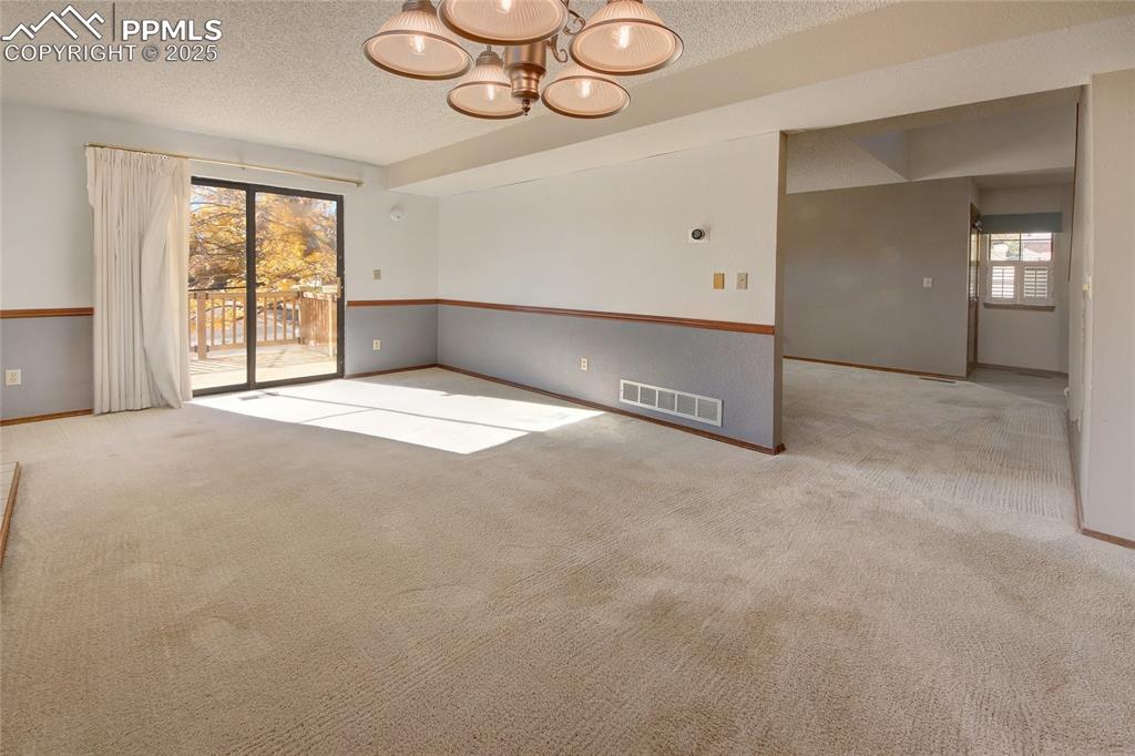 Image 9 of 33: Family room opens onto a wood deck