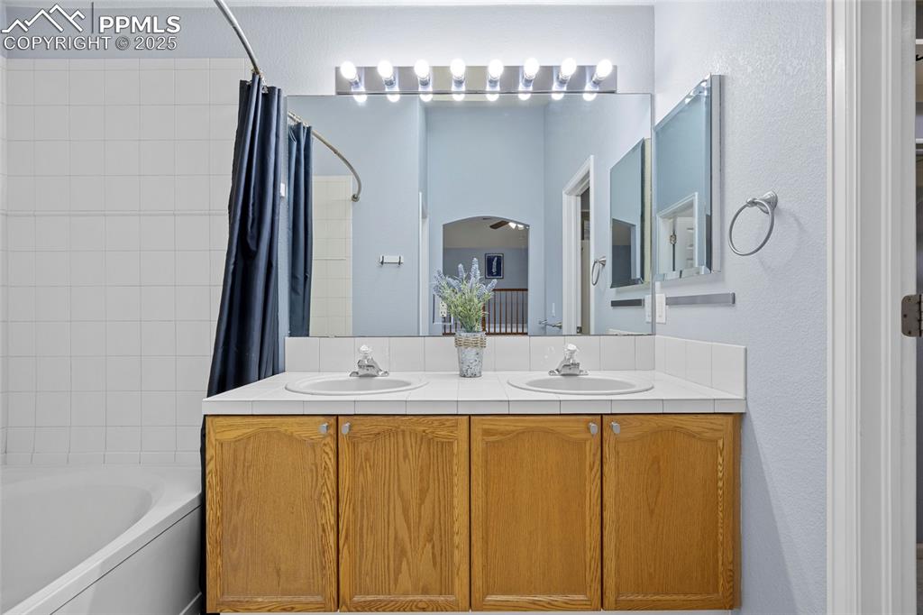 Image 29 of 50: Full bathroom featuring shower / bath combination with curtain and double v
