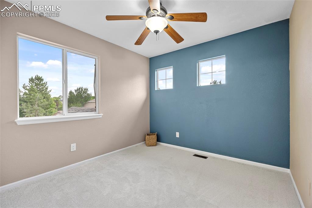Image 35 of 50: Carpeted empty room with ceiling fan and baseboards