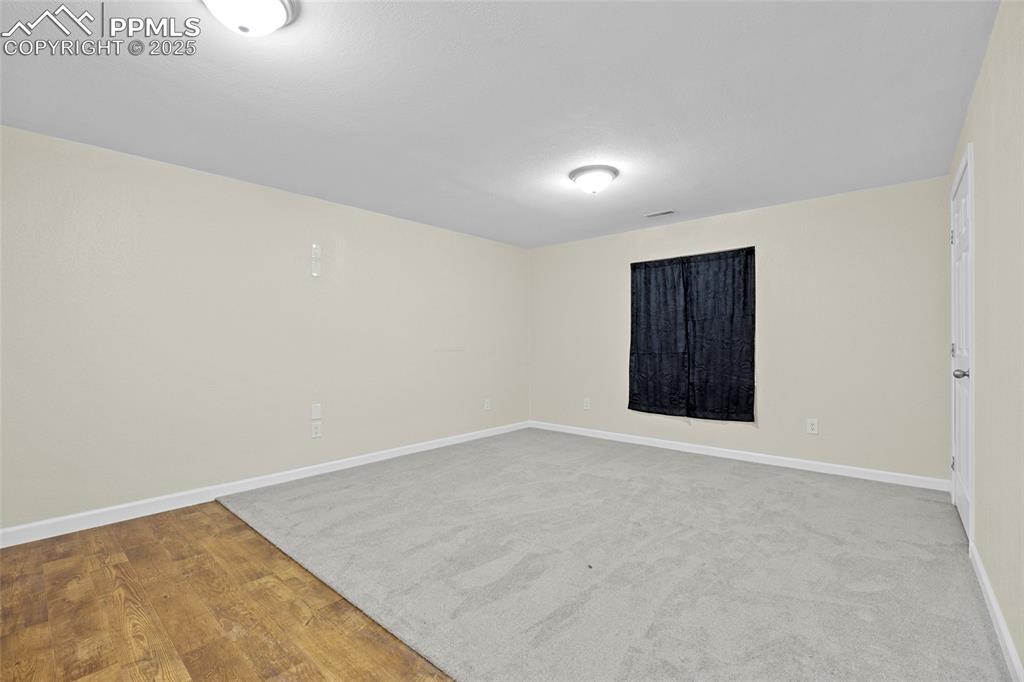Image 37 of 50: Spare room with baseboards and light wood-type flooring