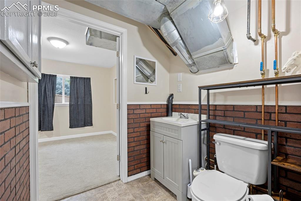 Image 40 of 50: Bathroom featuring vanity and wainscoting