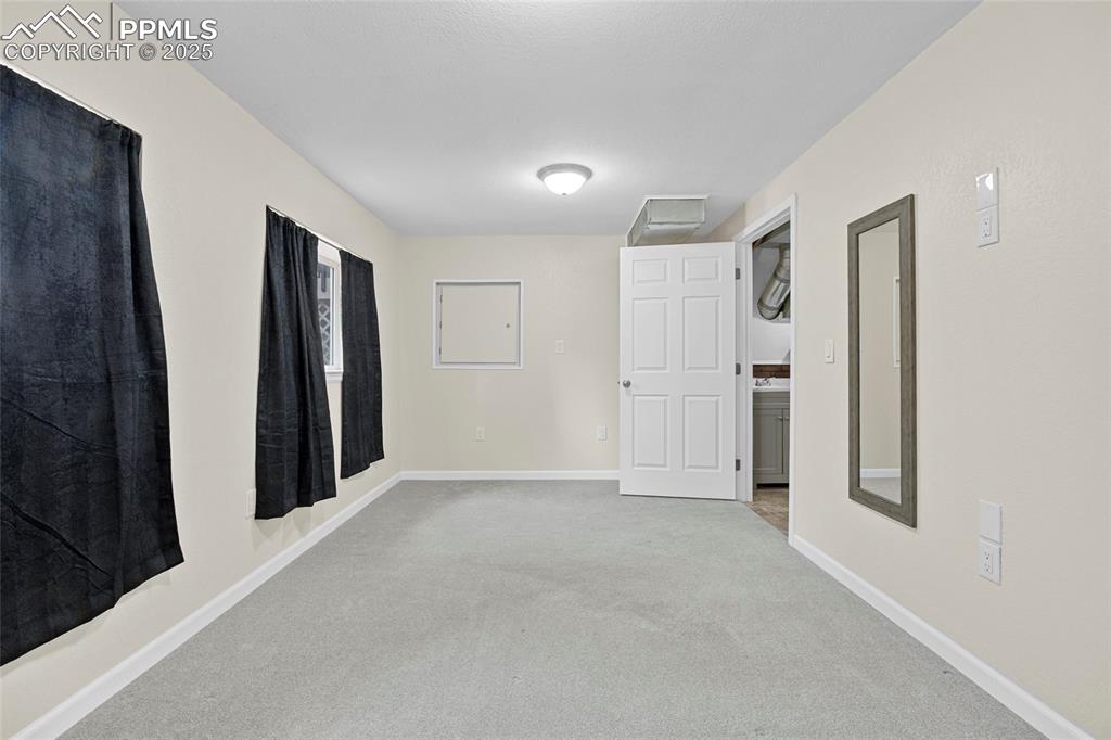 Image 42 of 50: Hall featuring carpet and attic access