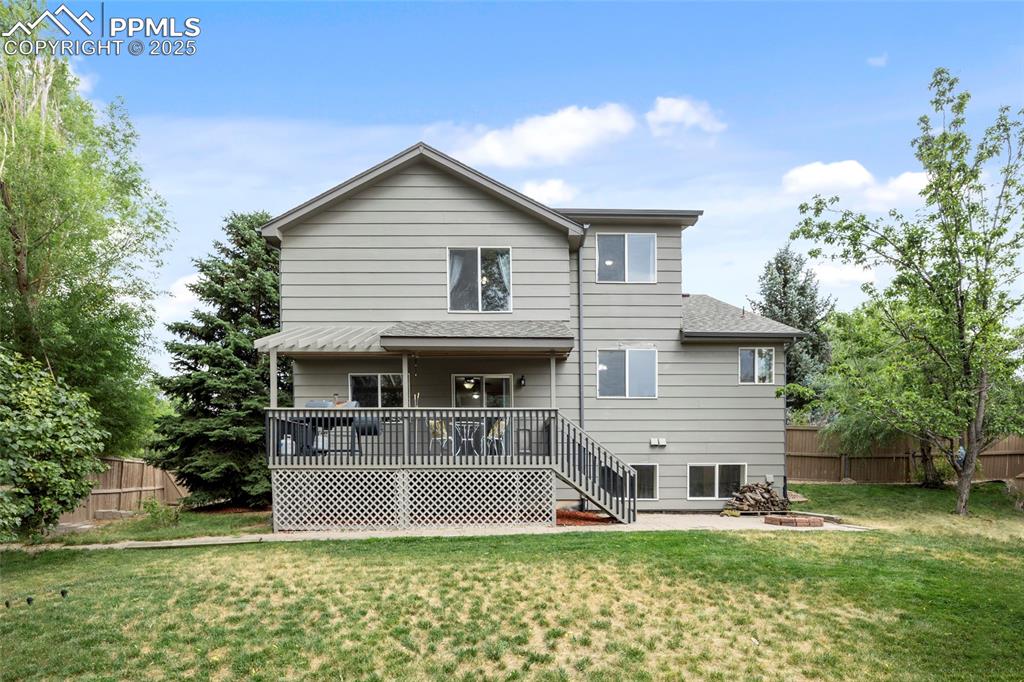 Image 47 of 50: Rear view of house with a deck, a patio area, and stairs