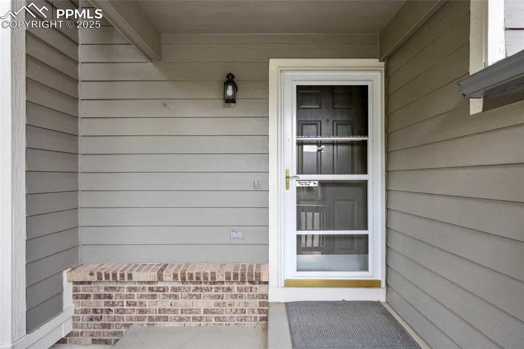 Image 9 of 50: Doorway to property with covered porch