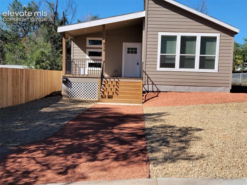 Image 1 of 41: Exterior featuring horizontal lap siding, a covered front porch with iron r