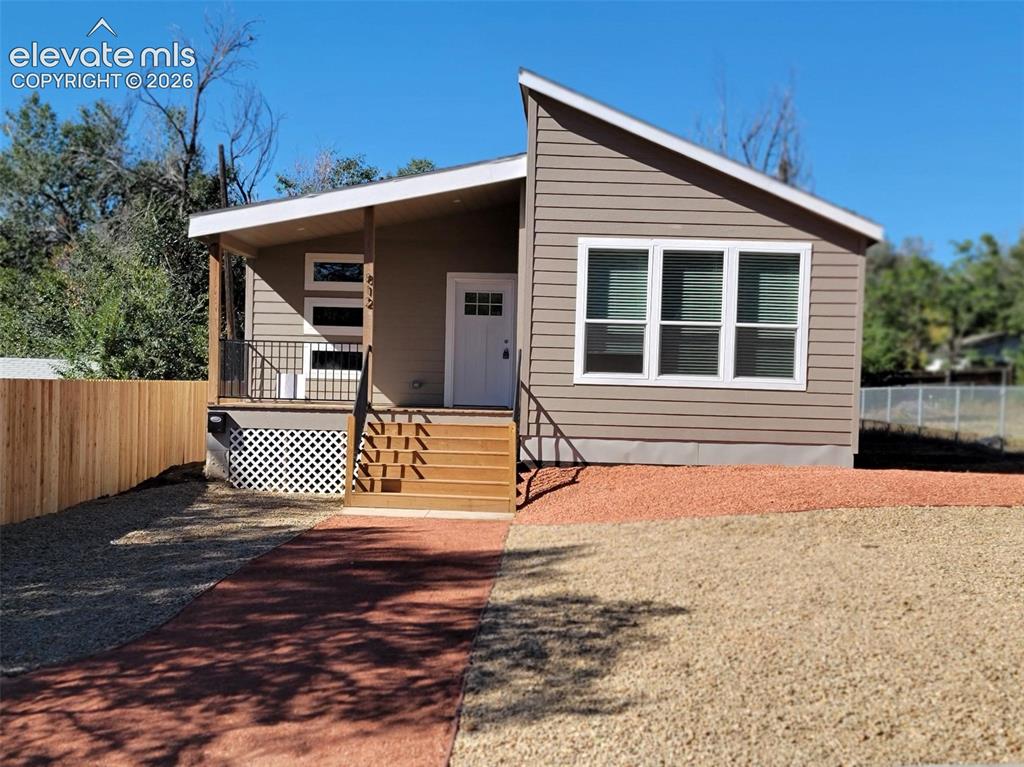 Image 26 of 41: Exterior featuring horizontal siding, a mono-pitch roofline, a covered fron
