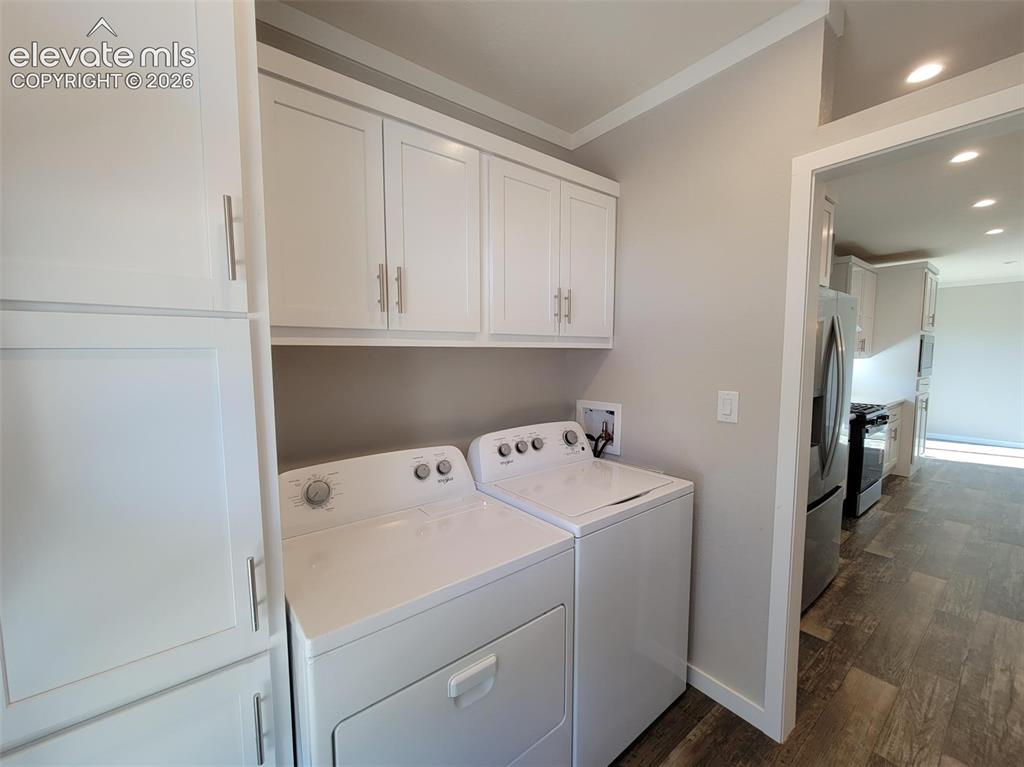 Image 37 of 41: Utility room featuring crisp white shaker-style cabinetry, overhead storage